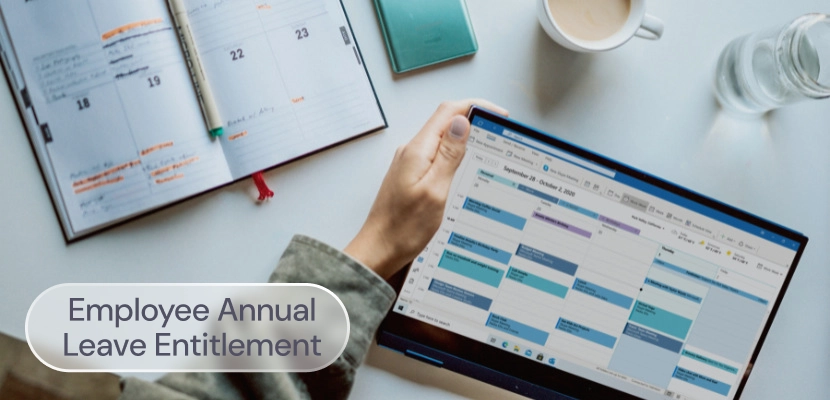 Someone planning holiday leave on a laptop, with the label: Employee annual leave entitlement