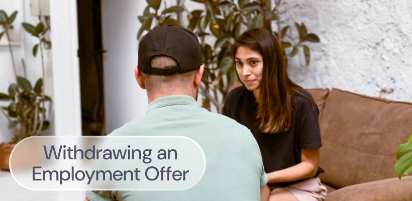 An HR manager consoling a candidate as she withdraws an employment offer