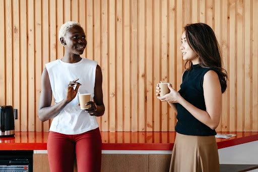 two women going for a long coffee break together in workplace