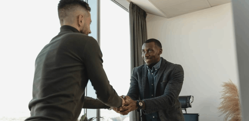 a candidate shaking hands with a potential employer after an interview