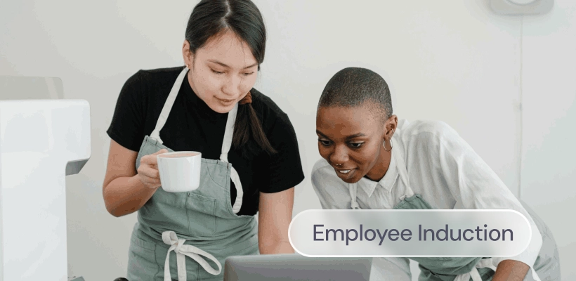 Two employees share a coffee during the induction process
